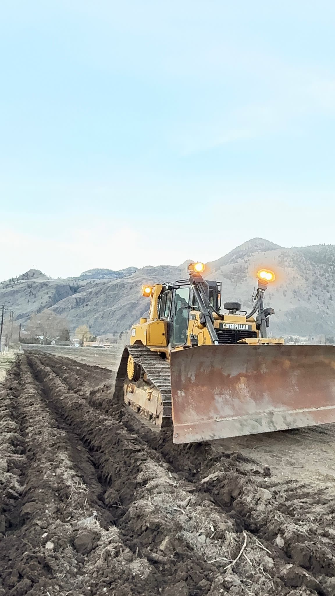 Close-up of Caterpillar dozer preparing land for vineyard rows in Okanagan