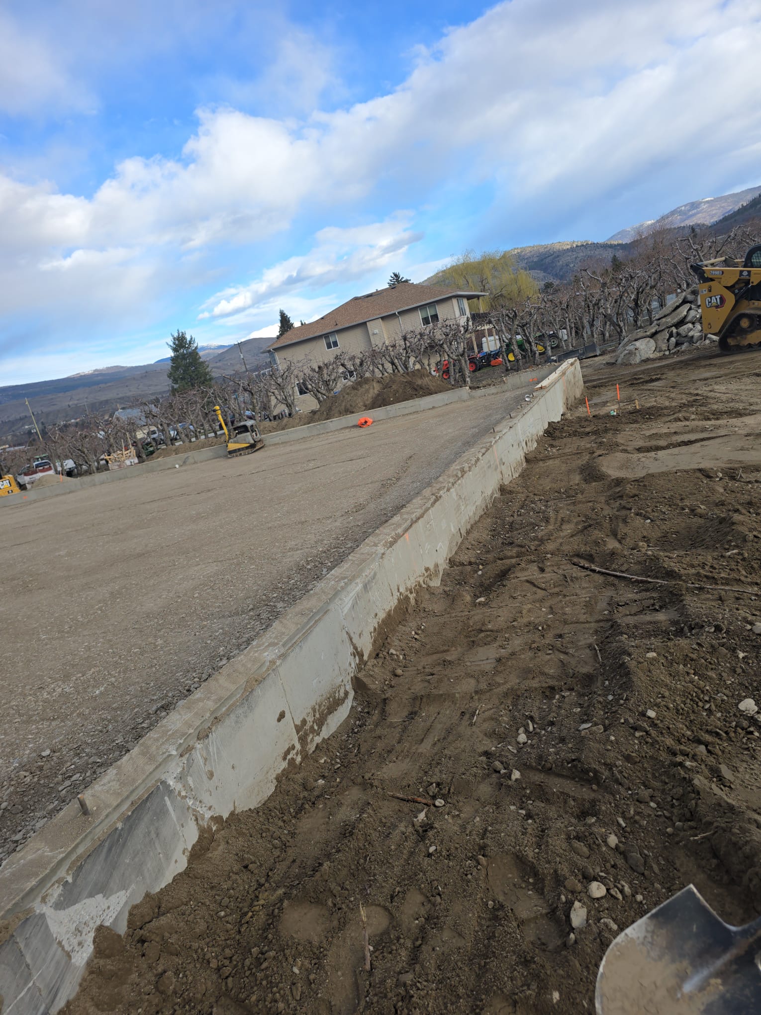 Concrete retaining wall constructed next to an Okanagan orchard